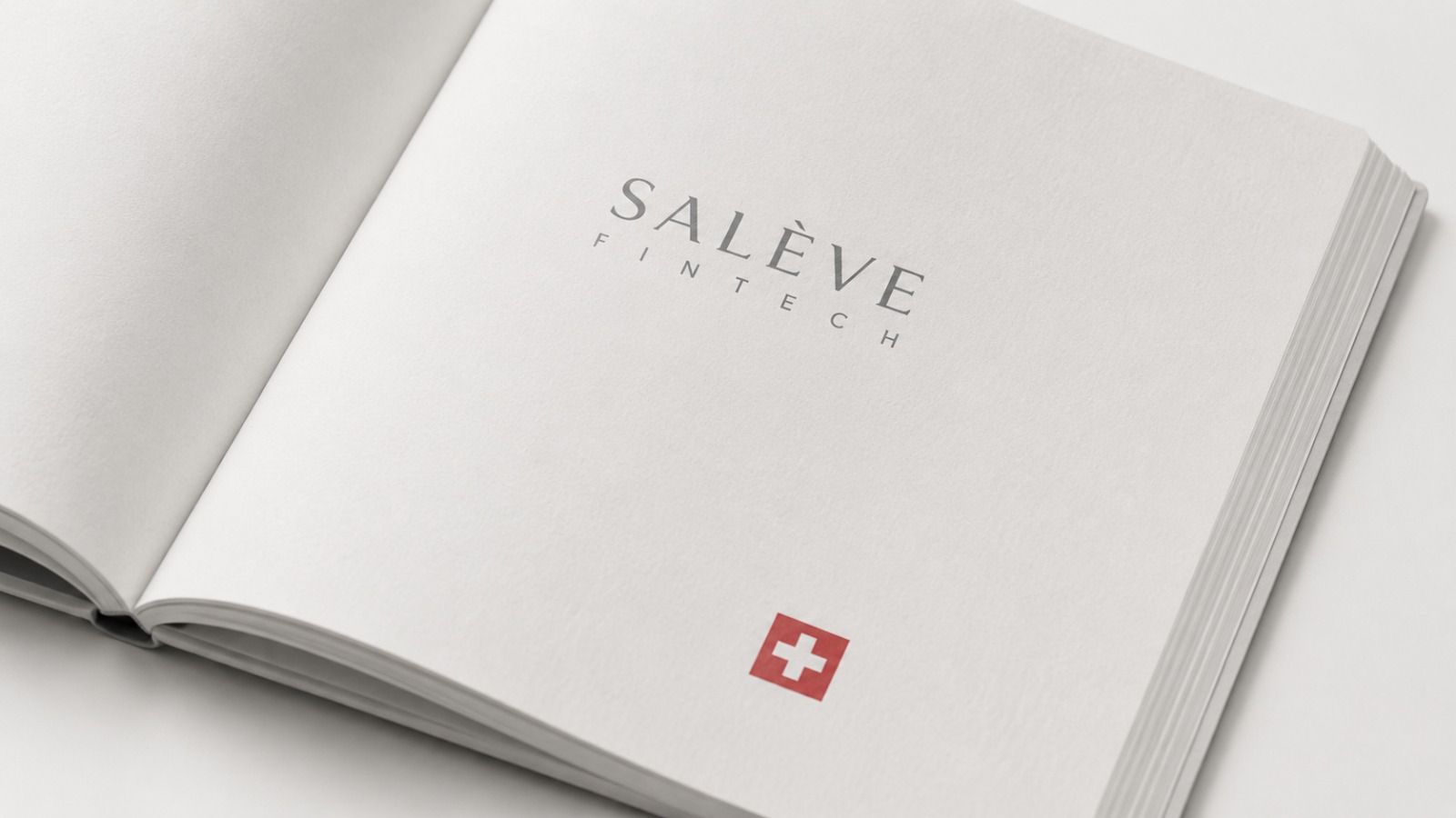 The Salève Fintech brand embossed on an open book beside the Swiss flag